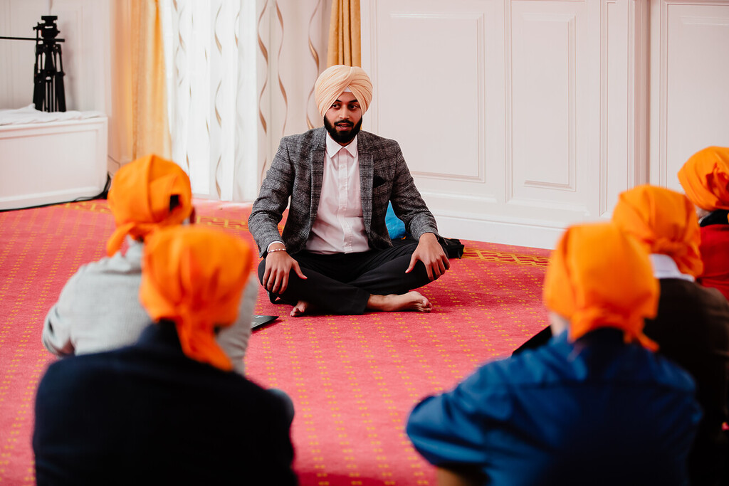 Sikh man sitting cross legged on the floor